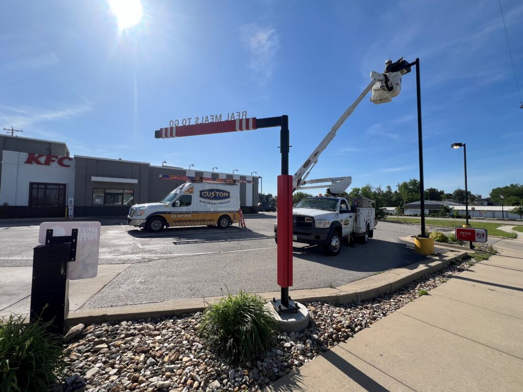 Bucket truck electrician fixing parking lot light